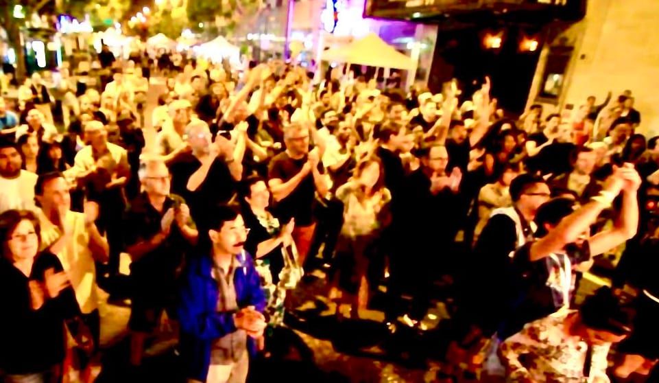 A packed crowd dancing at a Doug Ellington street show